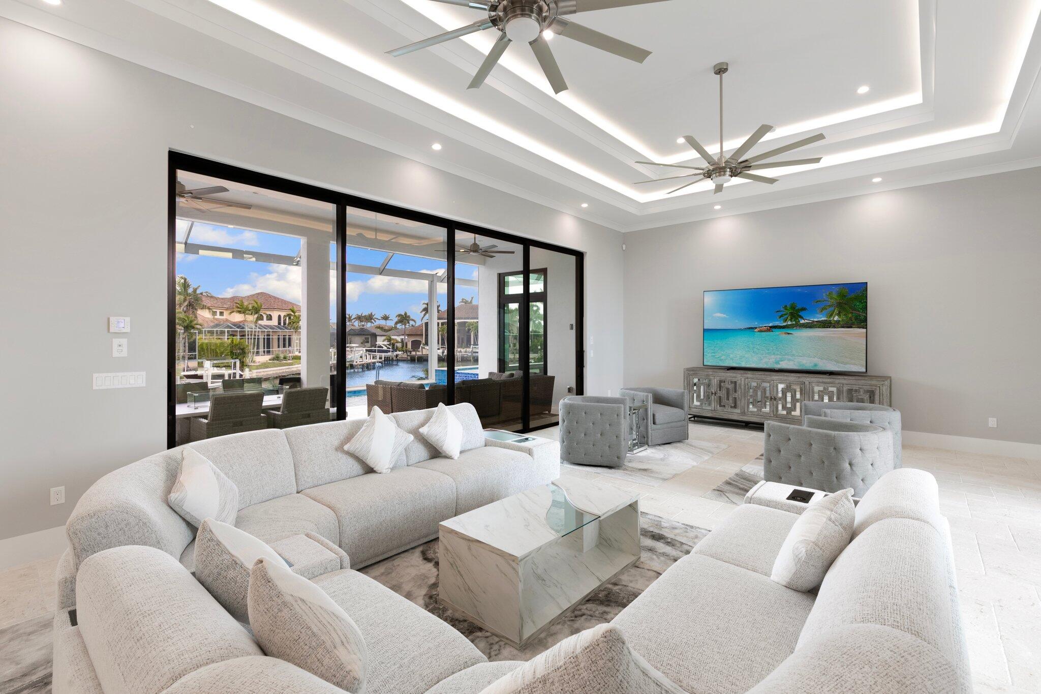 1960 San Marco Road Marco Island, FL 34145 - Photo 7 of 66 a living room with furniture ceiling fan and a large window