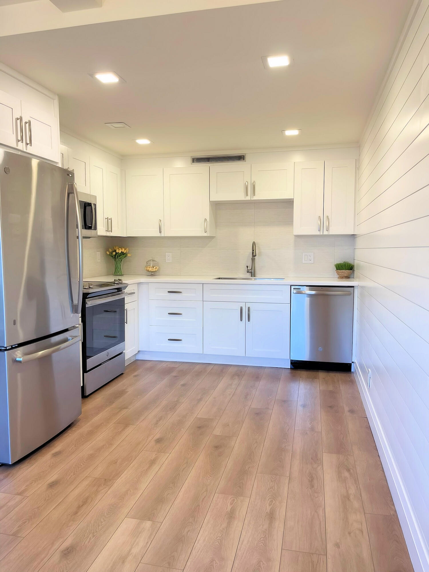 1030 Rexford B Boca Raton, FL 33434 - Photo 9 of 27 a kitchen with wooden cabinets and stainless steel appliances