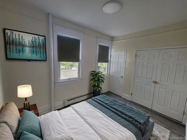 a bedroom with a bed and a window