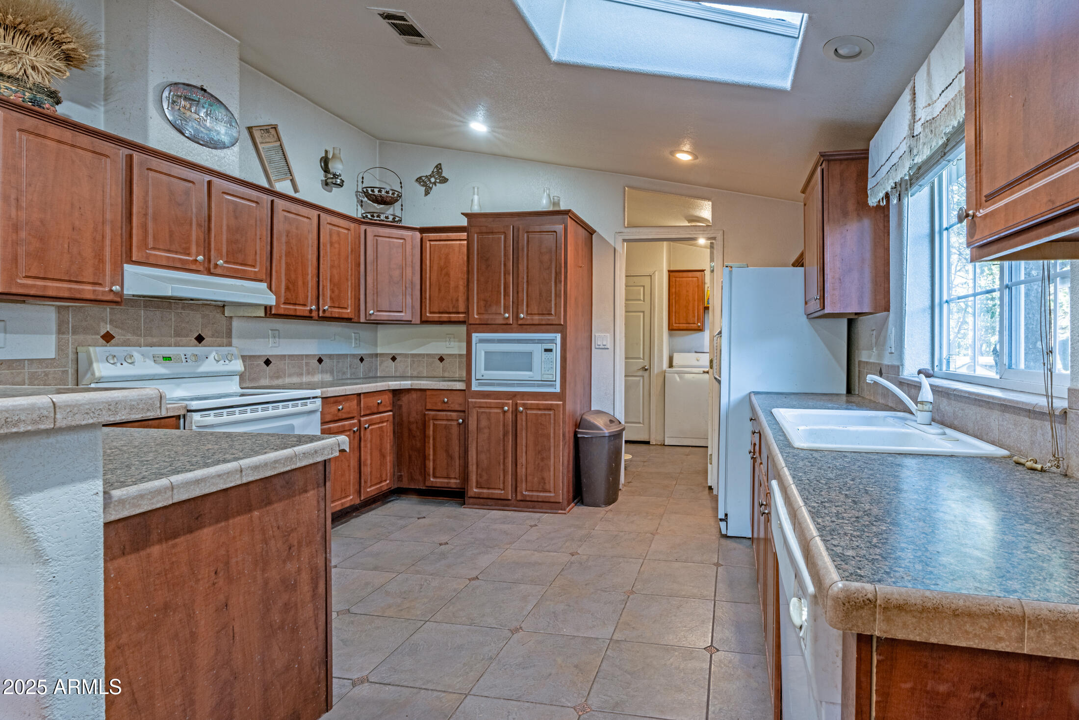 2179 Hackamore Drive Overgaard, AZ 85933 - Photo 5 of 26 a kitchen with a stove sink and a refrigerator