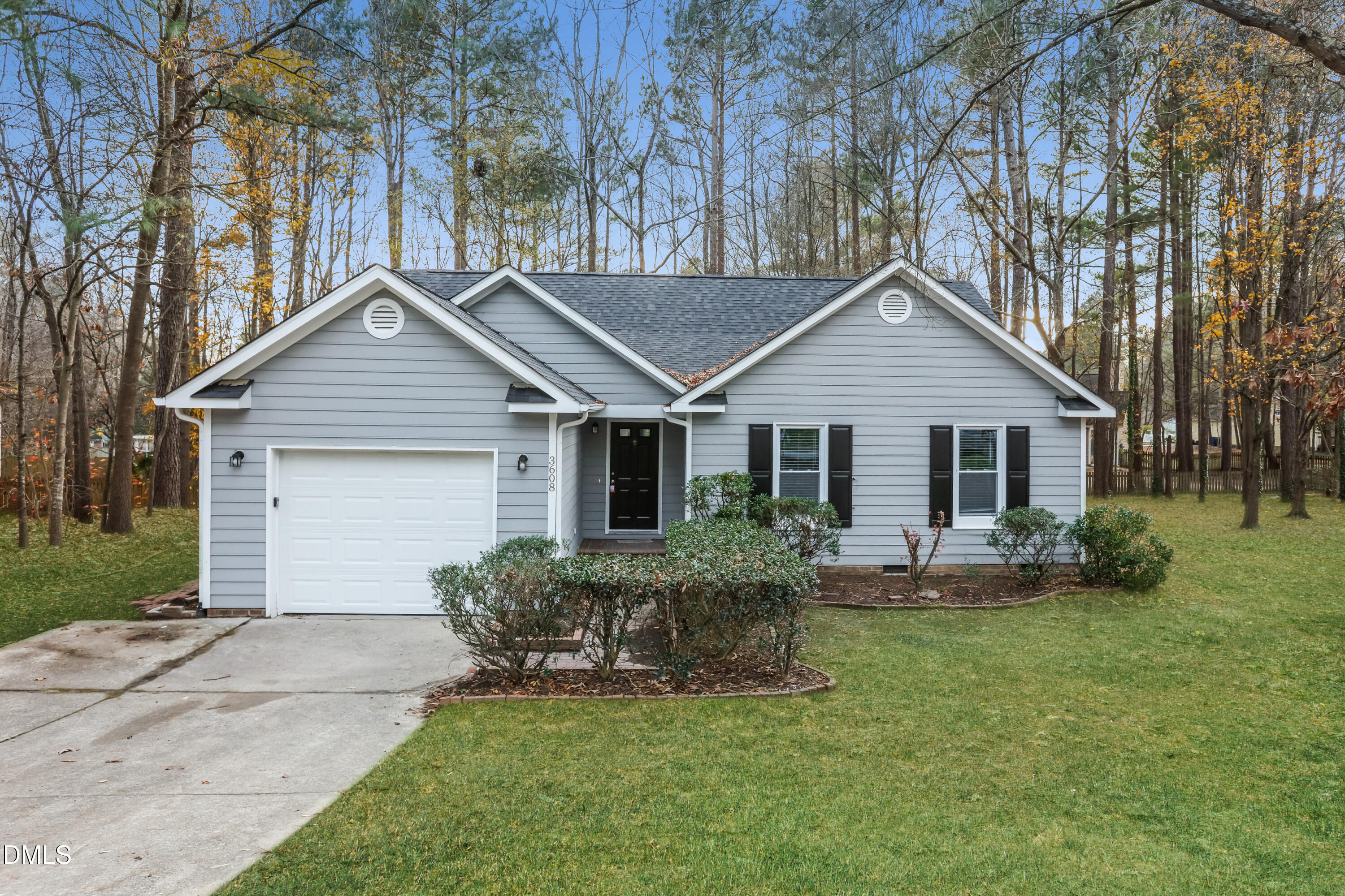 a front view of house with a garden and yard