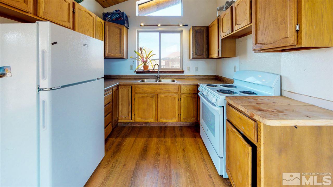 3000 Pinenut Road Gardnerville, NV 89410 - Photo 13 of 20 a kitchen with a refrigerator a sink and wooden floor