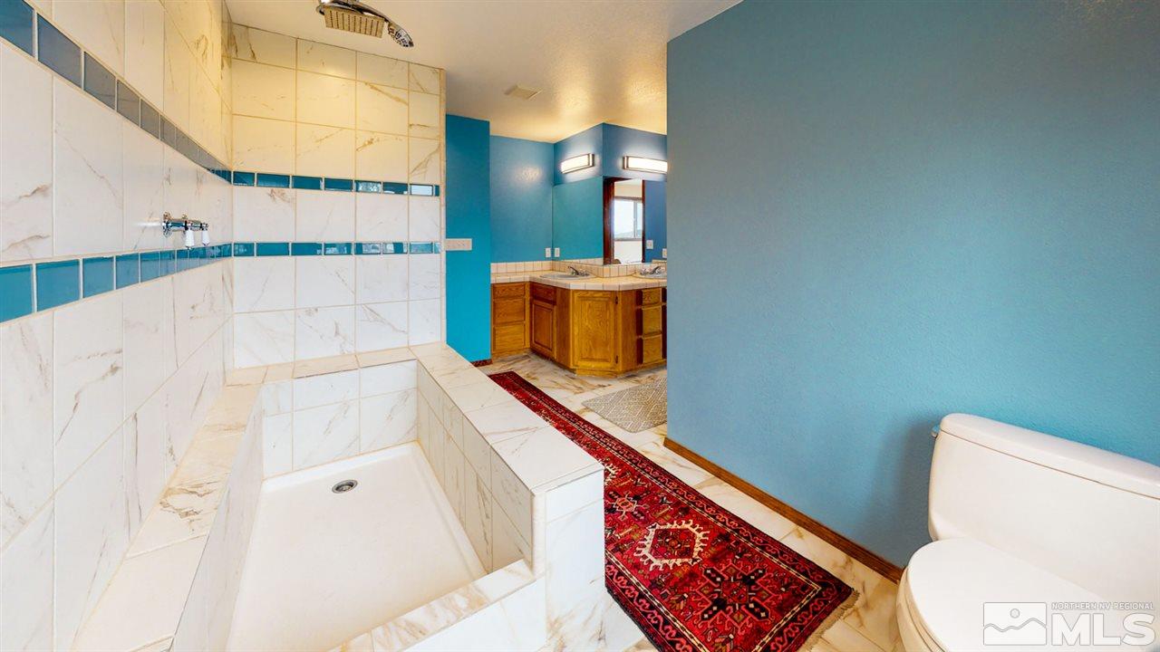 3000 Pinenut Road Gardnerville, NV 89410 - Photo 8 of 20 a bathroom with a sink and mirror with toilet