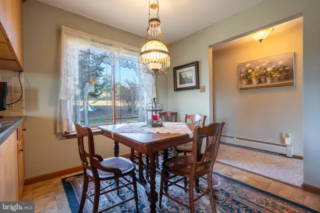 a kitchen view of living room stove and a microwave