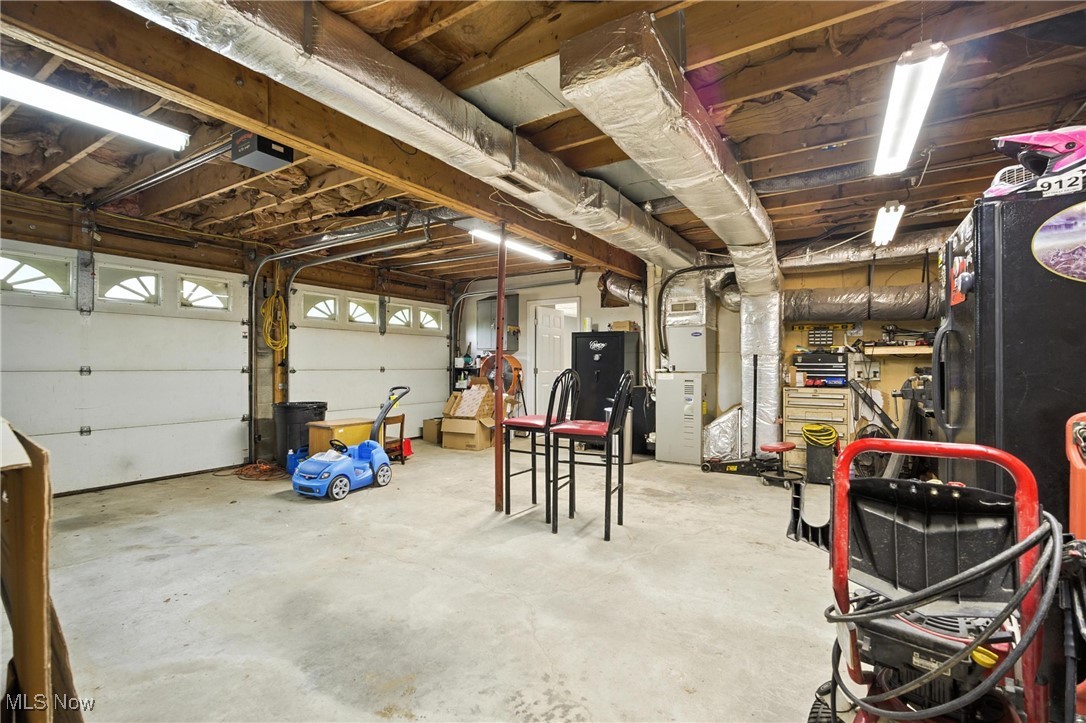 1371 Spider Ridge Road Parkersburg, WV 26104 - Photo 35 of 48 Garage featuring heating unit and a garage door opener