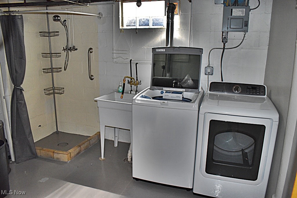 17600 Egbert Road Bedford, OH 44146 - Photo 41 of 49 Washroom featuring independent washer and dryer, laundry area, and concrete block wall