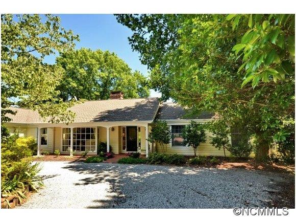 1001 Golden Road Tryon, NC 28782 - Photo 2 of 18 a front view of a house with a garden
