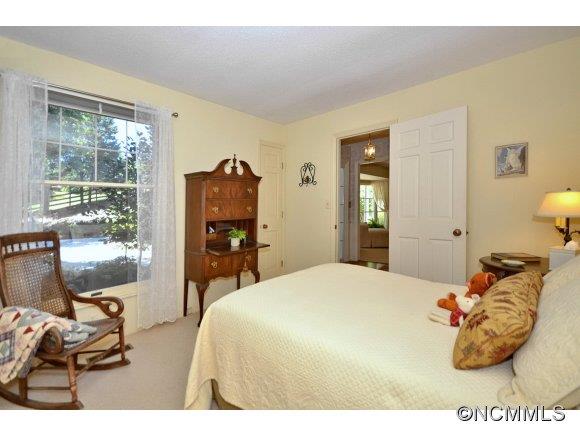 1001 Golden Road Tryon, NC 28782 - Photo 15 of 18 a bedroom with a bed and wooden floor