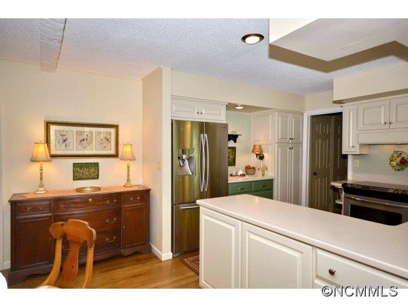 1001 Golden Road Tryon, NC 28782 - Photo 6 of 18 a kitchen with stainless steel appliances kitchen island granite countertop a refrigerator and a stove top oven