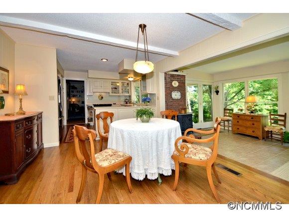 1001 Golden Road Tryon, NC 28782 - Photo 7 of 18 a living room with furniture a fireplace and a chandelier