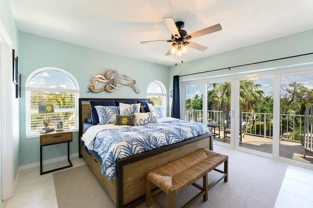 a bedroom with a large bed and a chandelier