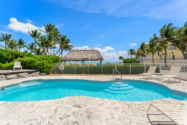 a swimming pool with outdoor seating and yard