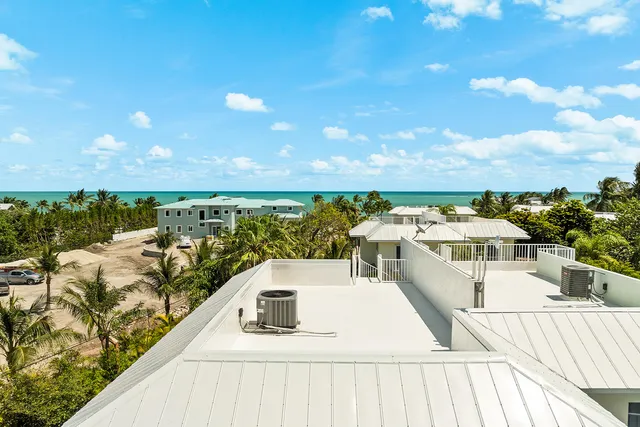 a view of a patio with lawn chairs