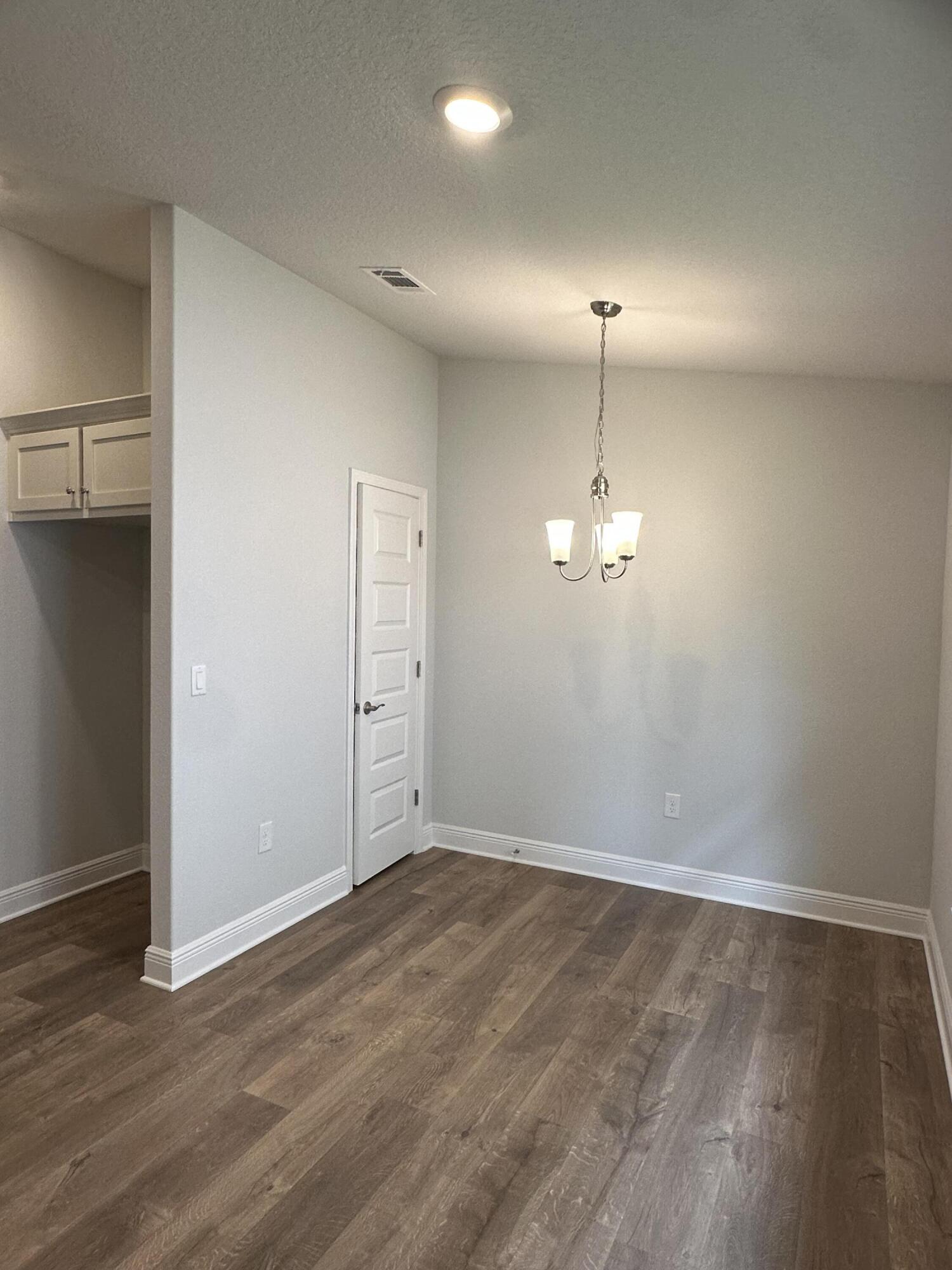 191 Ridgeway Circle Crestview, FL 32536 - Photo 11 of 26 an empty room with wooden floor and windows