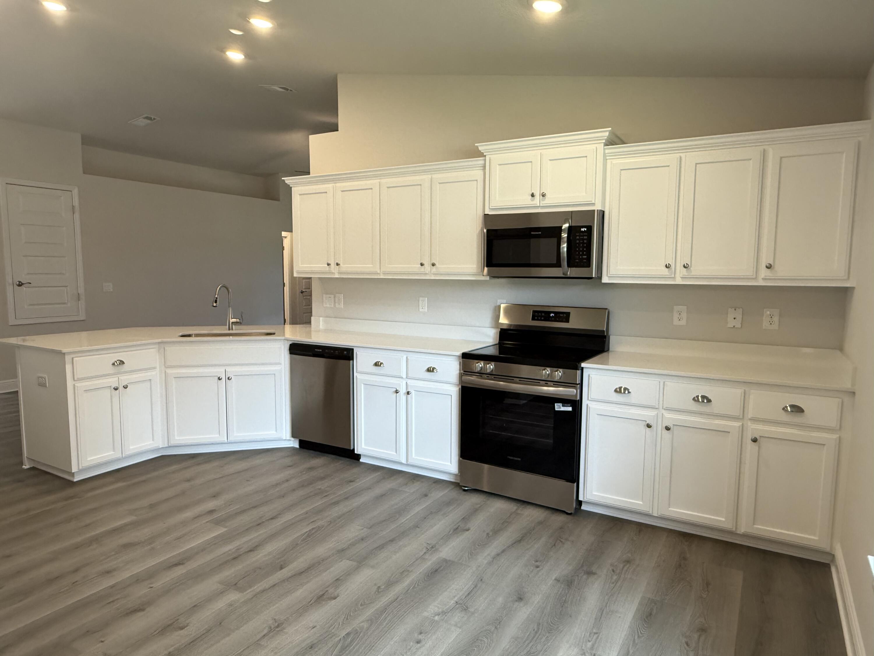 191 Ridgeway Circle Crestview, FL 32536 - Photo 12 of 21 a kitchen with a white cabinets and wooden floor