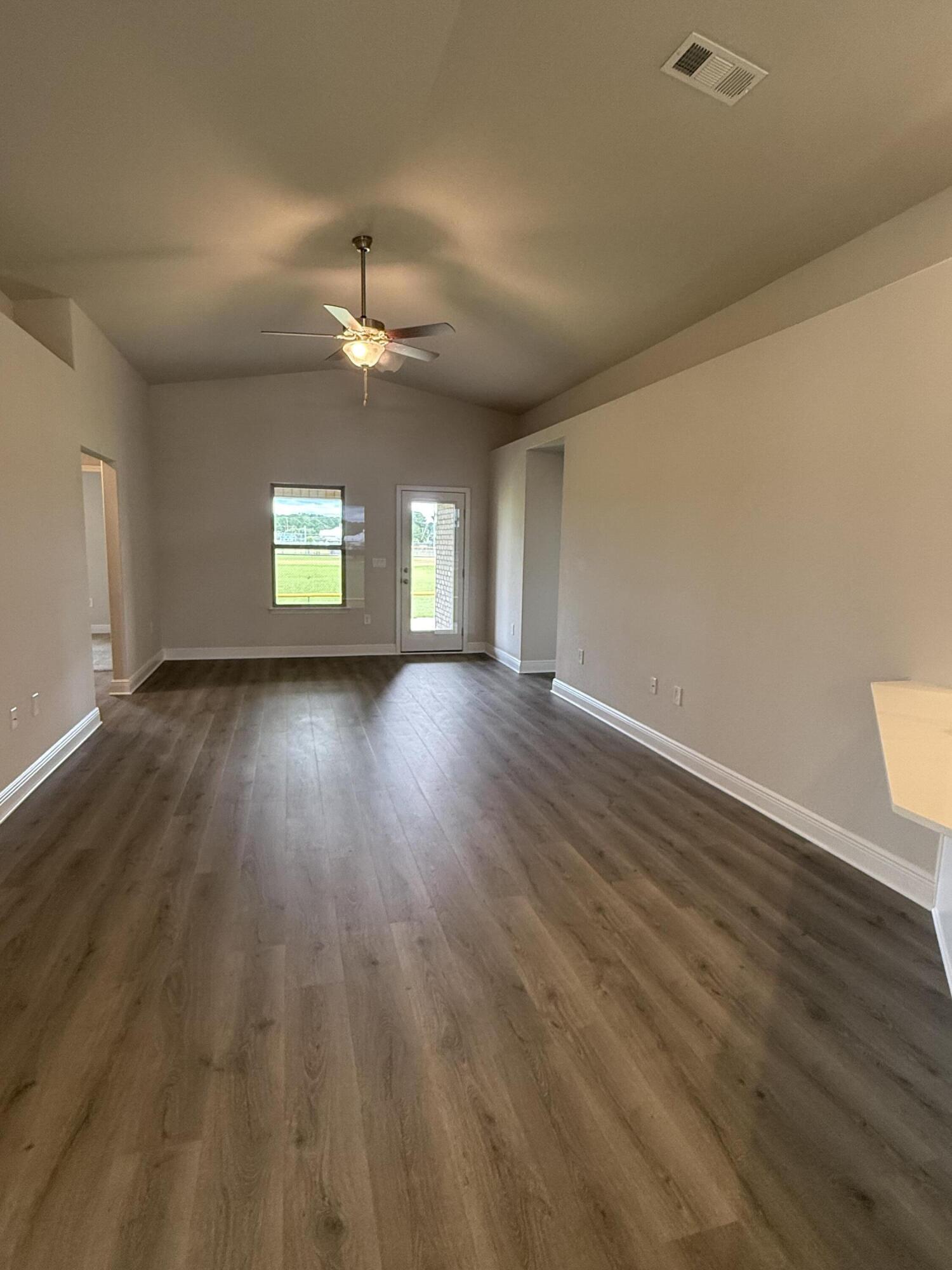 191 Ridgeway Circle Crestview, FL 32536 - Photo 14 of 21 wooden floor in an empty room with a window