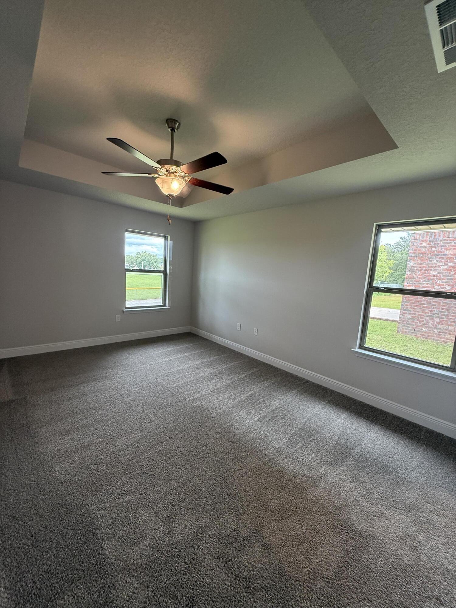 191 Ridgeway Circle Crestview, FL 32536 - Photo 15 of 21 an empty room with windows and ceiling fan