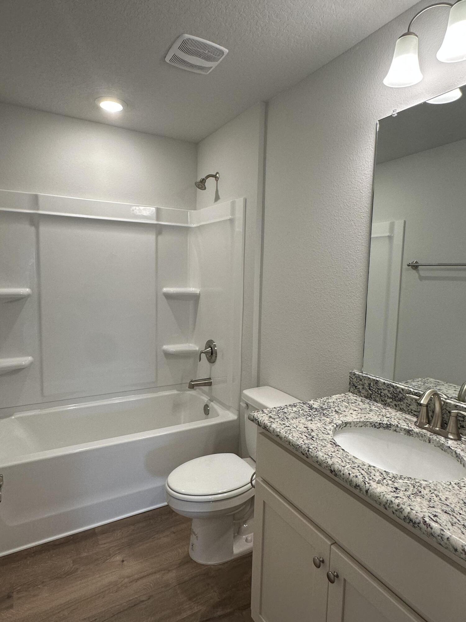 191 Ridgeway Circle Crestview, FL 32536 - Photo 15 of 26 a bathroom with a granite countertop sink a toilet and shower