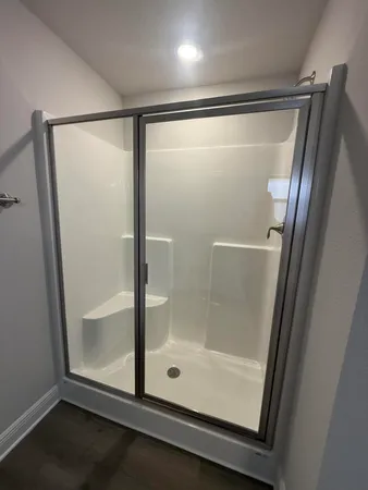 an empty room with windows and closet