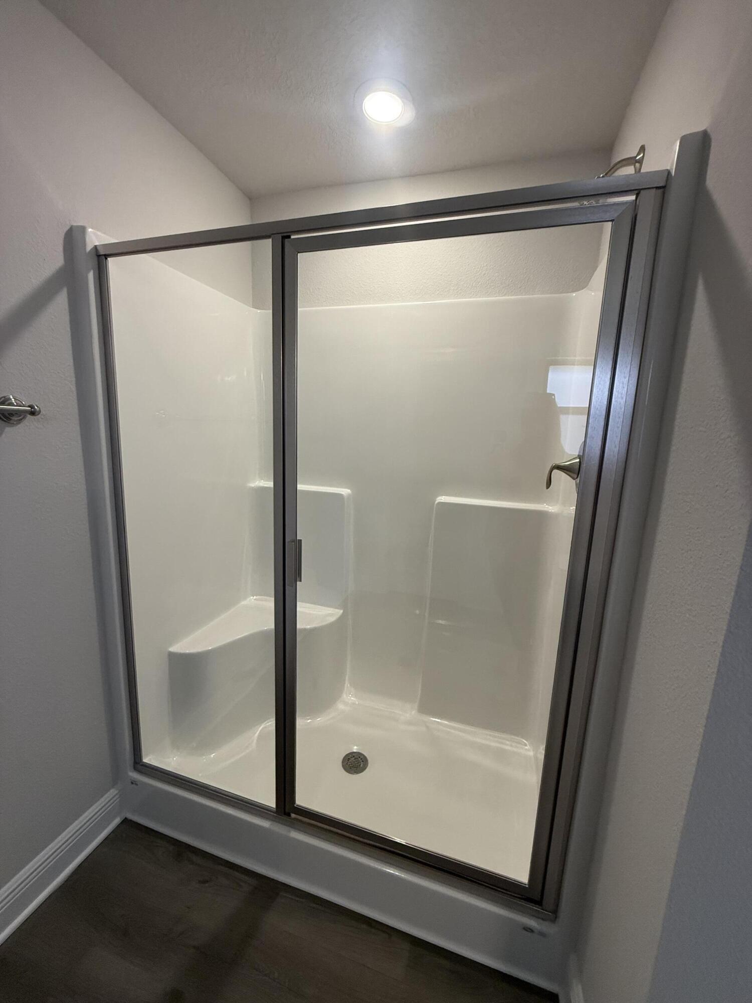 191 Ridgeway Circle Crestview, FL 32536 - Photo 18 of 21 a bathroom with a glass shower door and mirror