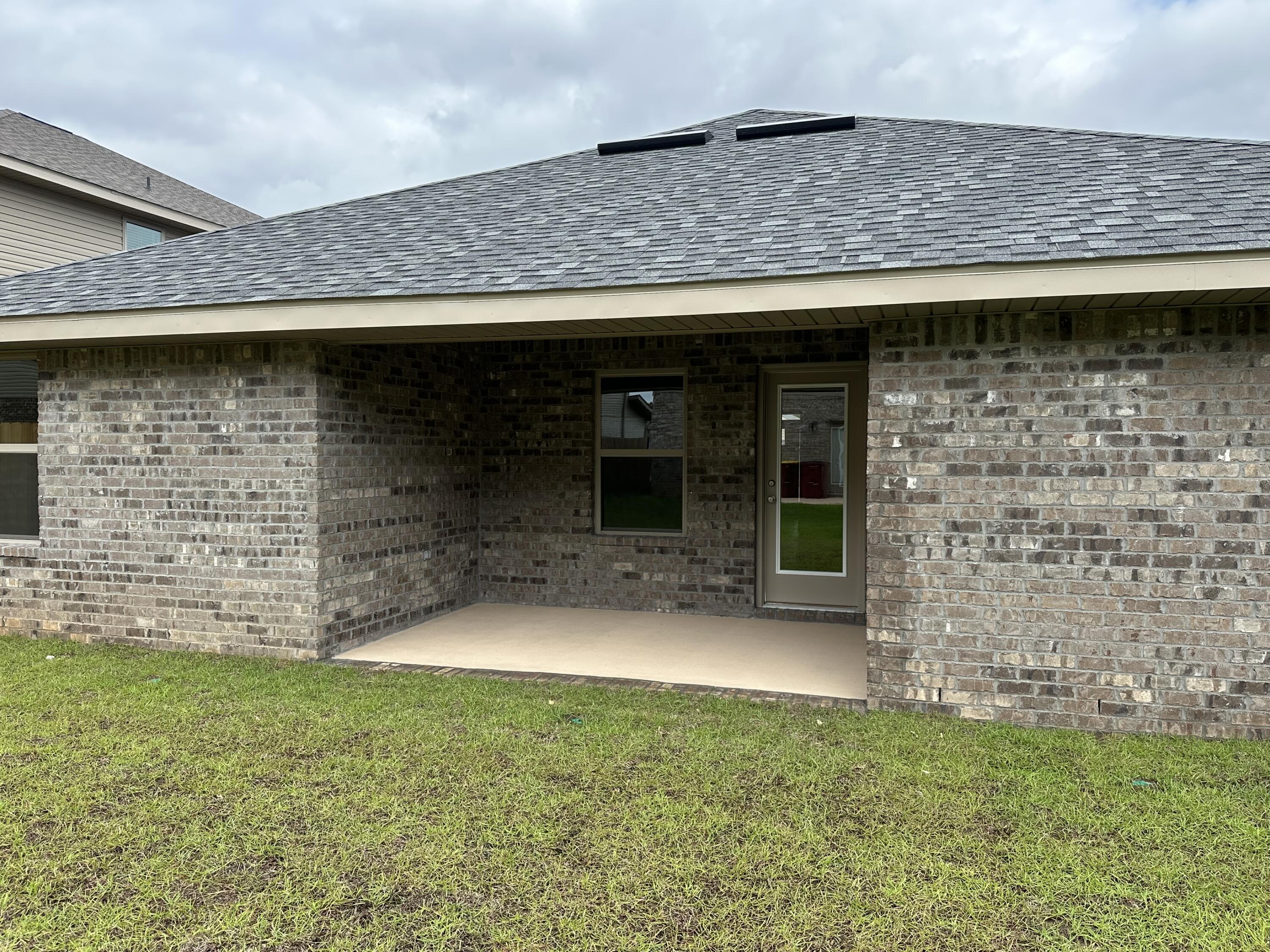 191 Ridgeway Circle Crestview, FL 32536 - Photo 24 of 26 a front view of a house with a garden