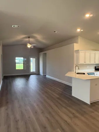 an empty room with wooden floor and window