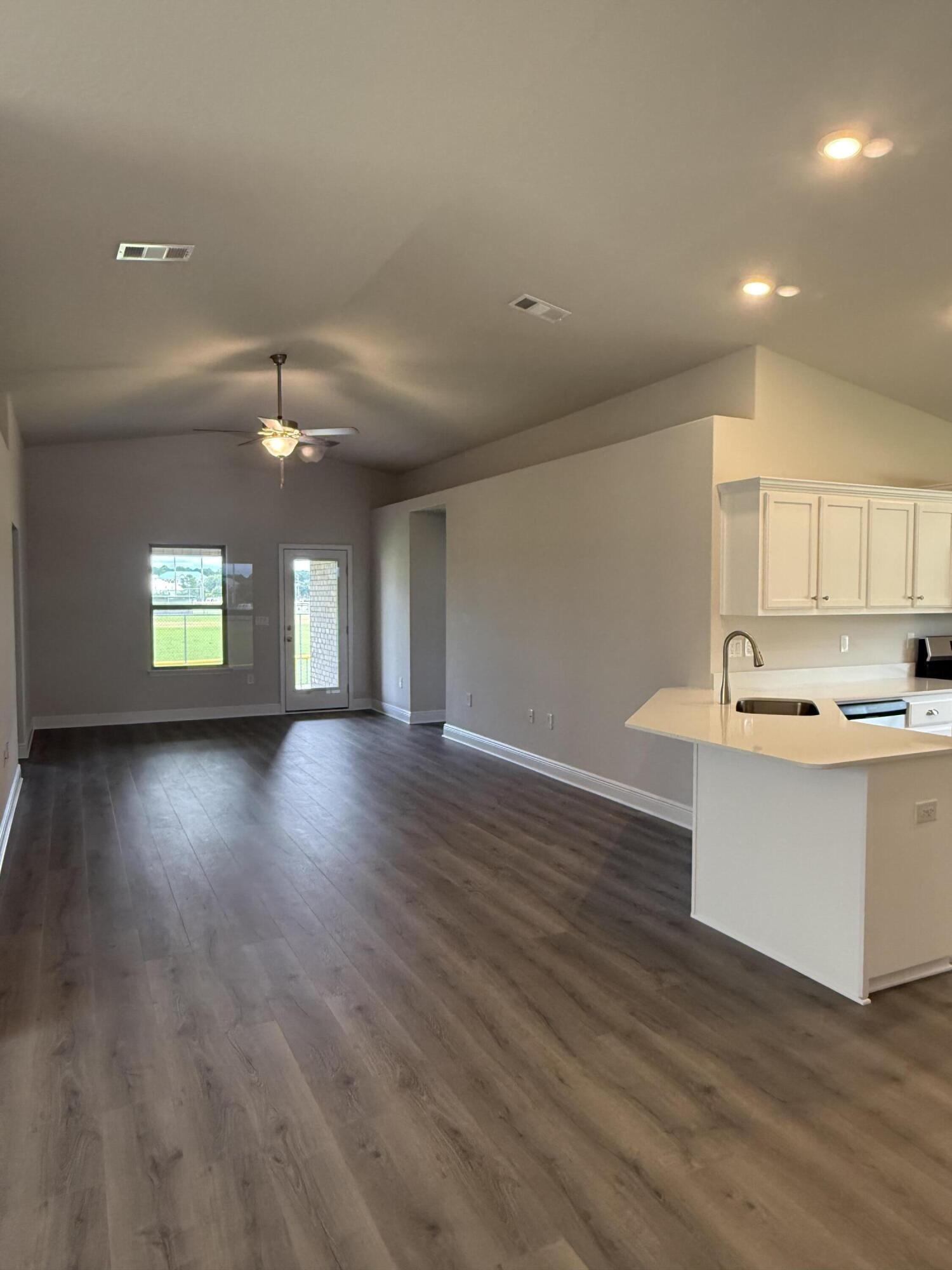 191 Ridgeway Circle Crestview, FL 32536 - Photo 8 of 21 an empty room with wooden floor and window