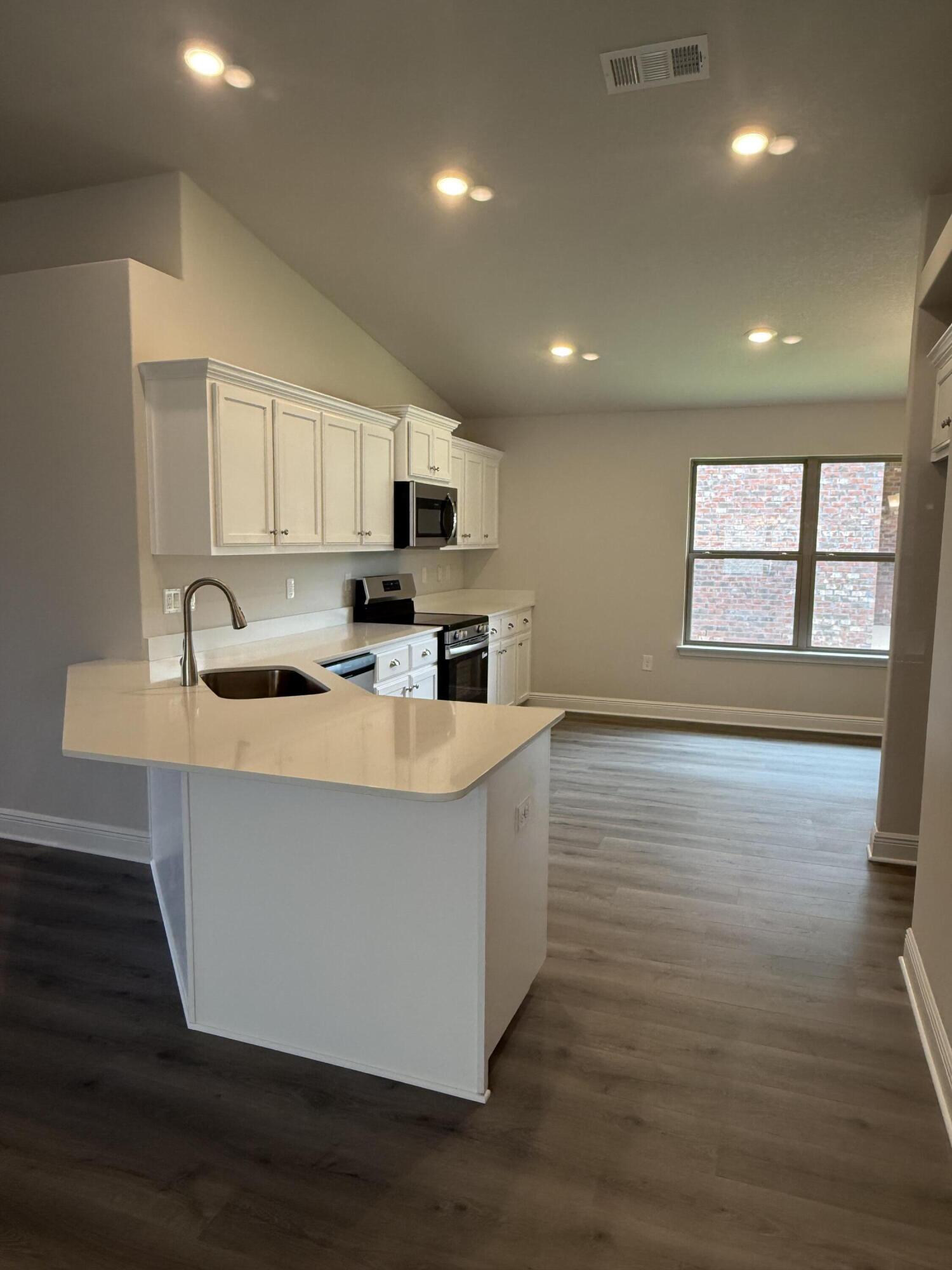 191 Ridgeway Circle Crestview, FL 32536 - Photo 9 of 21 a kitchen with stainless steel appliances granite countertop a sink a stove a microwave a sink a refrigerator and cabinets