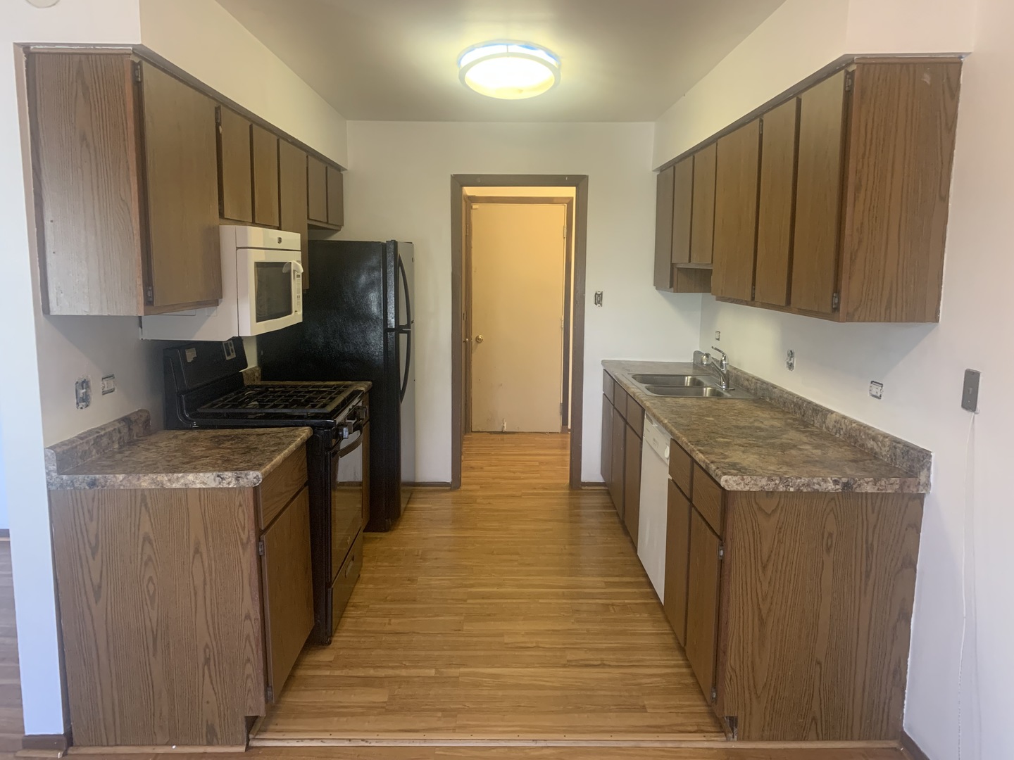 31 Churn Road Matteson, IL 60443 - Photo 4 of 10 a kitchen with granite countertop wooden cabinets and stainless steel appliances
