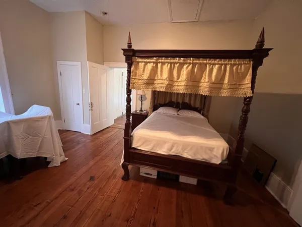 a bedroom with a bed and a mirror