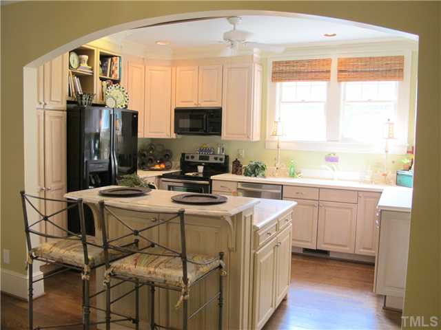 2238 The Circle Raleigh, NC 27608 - Photo 11 of 23 New Cabinet Hardware & Stainless Electric Range & Refrigerator Installed May, 2011. Custom Island with China/Stemware Storage and Recycle Center Built in 2008. White solid surface counters and sink along perimeter; Gorgeous Calcutta Marble Top at Island. Kitchen