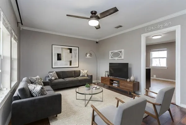 a living room with furniture and a flat screen tv