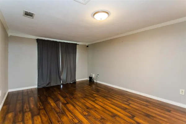 an empty room with wooden floor and closet