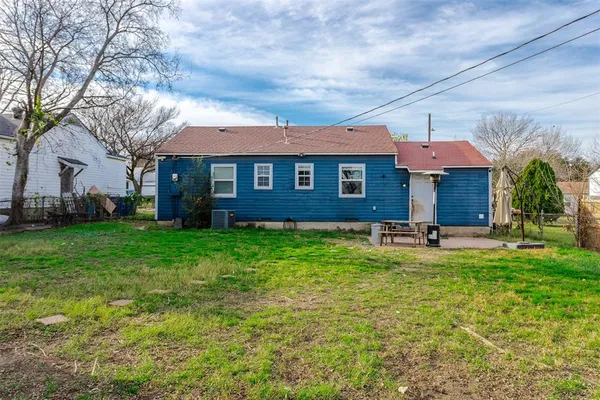 a view of a house with a swimming pool and a large tree