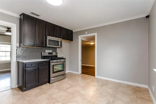 a kitchen with stainless steel appliances granite countertop a refrigerator and a stove top oven