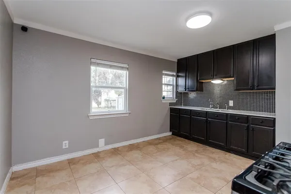 a kitchen with a sink and wooden cabinets