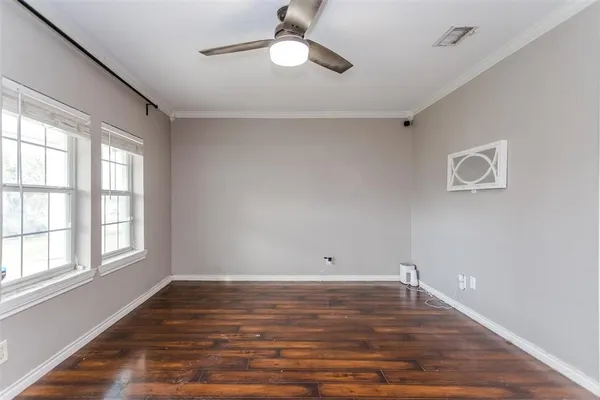 wooden floor in an empty room with a window