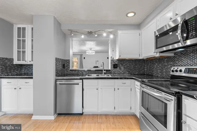a view of an empty room and wooden floor