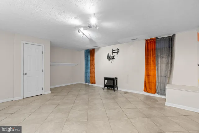 a view of a house with a wooden deck