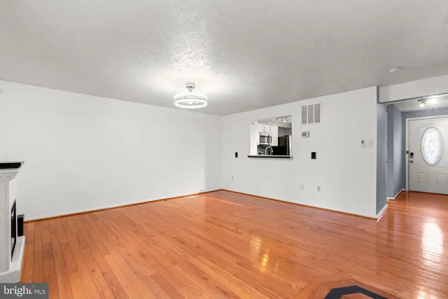 a kitchen with stainless steel appliances a stove a refrigerator and a microwave