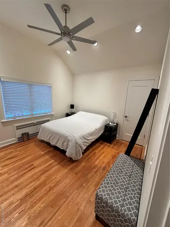 a bedroom with a bed and window