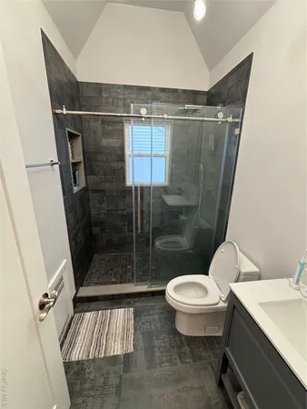 a bathroom with a toilet and a shower