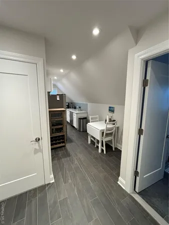a view of a room with furniture and wooden floor