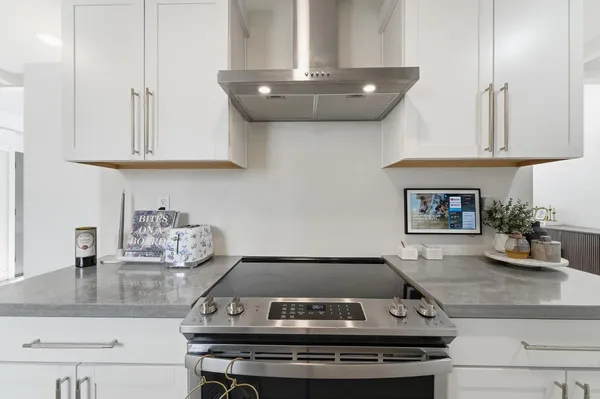 a kitchen with white cabinets and white appliances