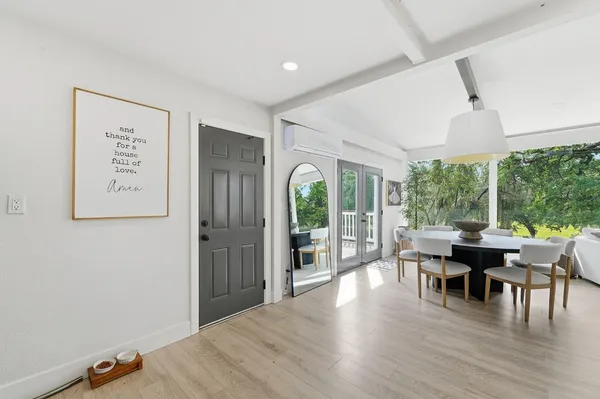 a view of a dining room with furniture large windows and wooden floor