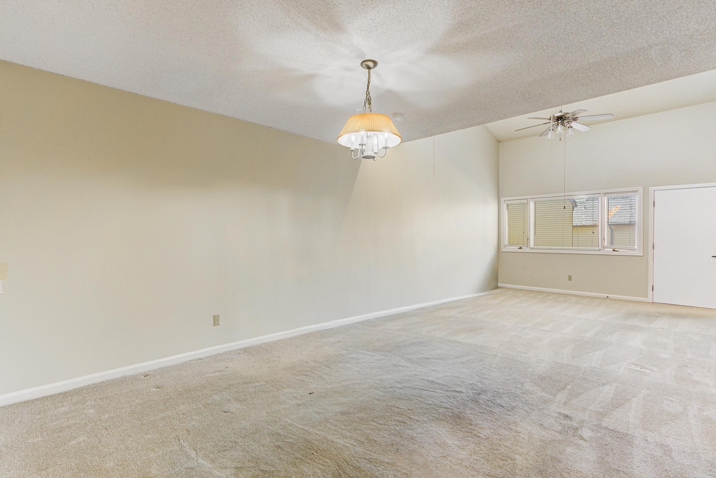 5013 Scheibler Road, Unit C1 Memphis, TN 38128 - Photo 8 of 36 Empty room featuring light colored carpet, a textured ceiling, and a ceiling fan