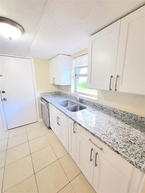 5338 Orange Avenue, Unit B Seffner, FL 33584 - Photo 4 of 8 a large white kitchen with a sink and cabinets
