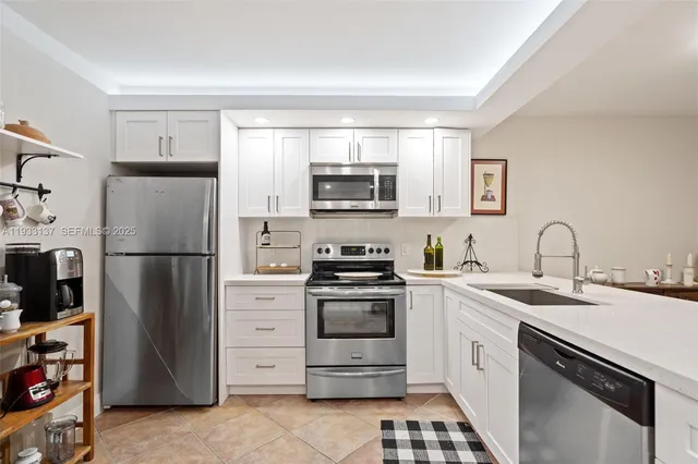 a kitchen with a refrigerator sink and microwave