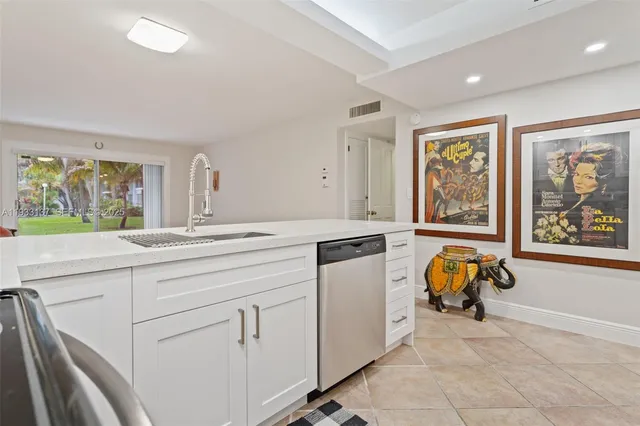 a kitchen with a stove a sink and a refrigerator