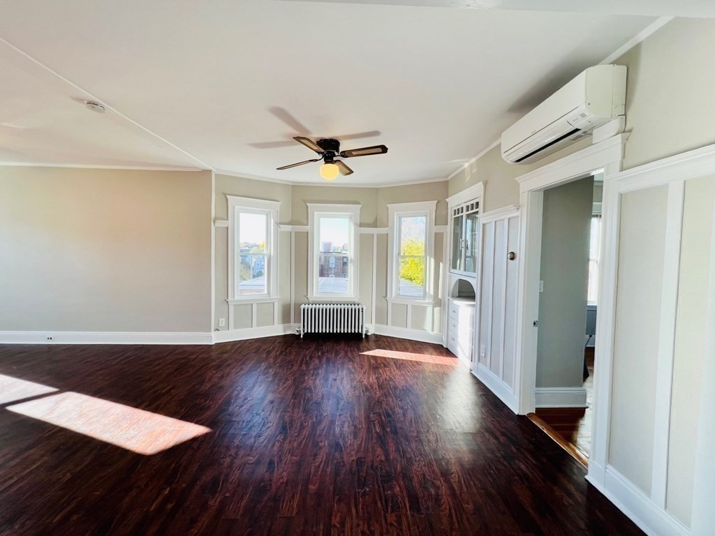 22 Gardena Street, Unit 3 Boston, MA 02135 - Photo 4 of 17 a view of an empty room with wooden floor and a window